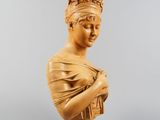 a wooden bust of a woman with a crown on her head