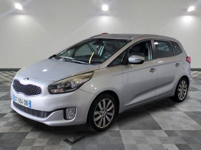 the silver car is parked on a checkered floor in the garage