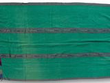 a green and blue blanket with fringes on a white background