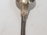 a spoon with a spoon handle on it on a table
