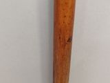 an old baseball bat with a wooden handle sitting on a table