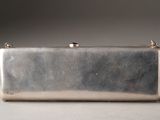 an image of a silver purse on a table