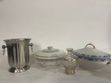 a silver vase, a silver cup, and a silver vase on a table