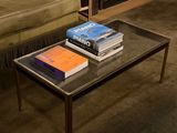 two books on a table in front of a fireplace