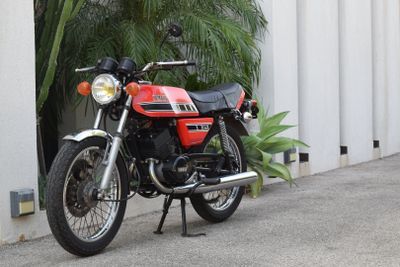 a red motorcycle parked on the side of the road