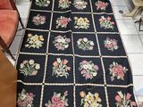 an image of a black rug with flowers on it