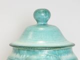 a blue bowl with a lid sitting on a table