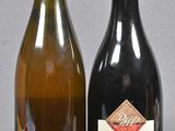 two bottles of wine sitting next to each other on a table