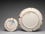 a white plate and a white plate with a blue and red design on it