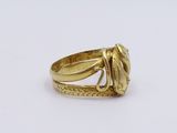 a close up of a gold ring on a white surface