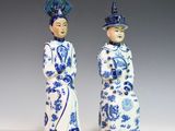 pair of blue and white figurines of a man and a woman
