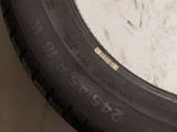 a close up of a tire on a white surface next to a pair of scissors