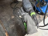 a sander and a sander on the floor in a garage