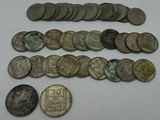some old coins are sitting on a table with a white background
