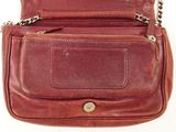 an image of a brown leather purse with a chain around it