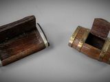 two small wooden boxes with metal handles on a white surface