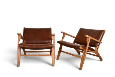 two brown leather lounge chairs with wooden arms and arms
