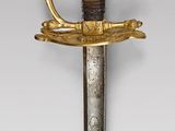 an old sword with a gold handle and a bird on it
