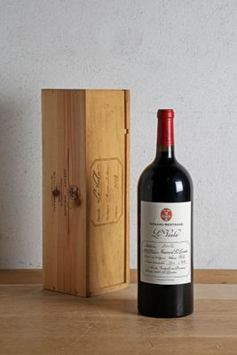 a bottle of wine sitting next to a wooden box
