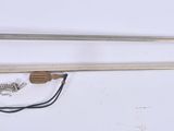two swords that are laying on a white surface
