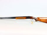 a shotgun with a wooden barrel and a wooden handle