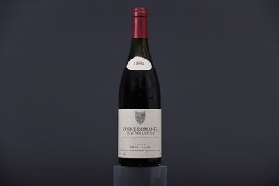 a bottle of wine sitting on top of a black table