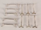 six pairs of silver plated spoons and forks on a white surface