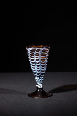 a glass cup that is sitting on a table