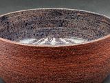 a brown bowl that is sitting on a table