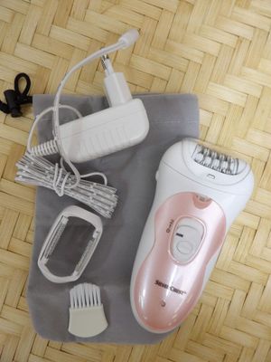 a pink and white electric shaver on a table