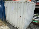 a white container sitting in the dirt next to a blue container
