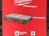 the milwaukee packout box is being held up by a person
