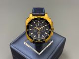 the watch is sitting on a blue box on the table