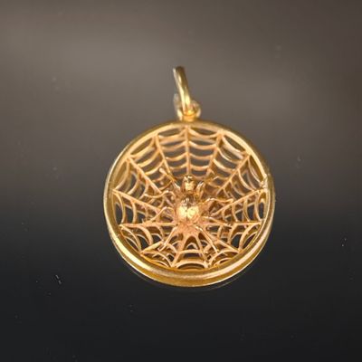 pendentif plaqué or représentant une toile d'araignée avec une étoile au centre