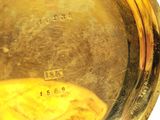 a close up of a gold plate with a clock on it