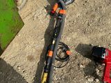a hose that is laying on the ground next to a tool