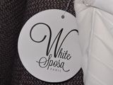 a white dress tag hanging on a black and white dress