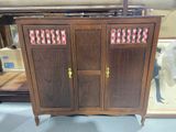 a wooden cabinet with a floral design on it
