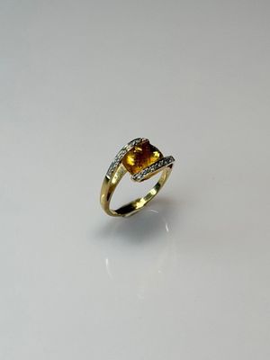 a close up of a ring on a table with a white background