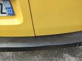a close up of a yellow car with a license plate on it