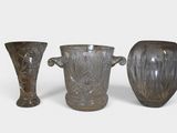 three vases sitting next to each other on a white surface
