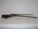 an old gun with a wooden handle and a wooden barrel