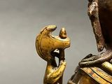 a statue of a man holding a bird in his hand