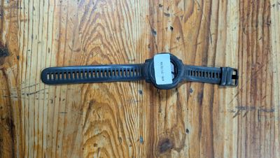 a watch that is laying on a wooden floor