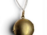 a close up of a gold locke on a white background