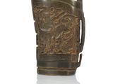 a brown vase with a dragon on it on a white surface