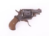 an old revolver with a wooden handle on a white surface