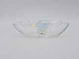 a clear glass bowl sitting on top of a white table