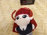 a small stuffed animal sitting on a table next to a box