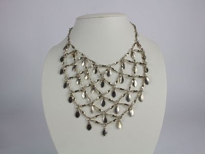 a close up of a necklace on a mannequin mannequin